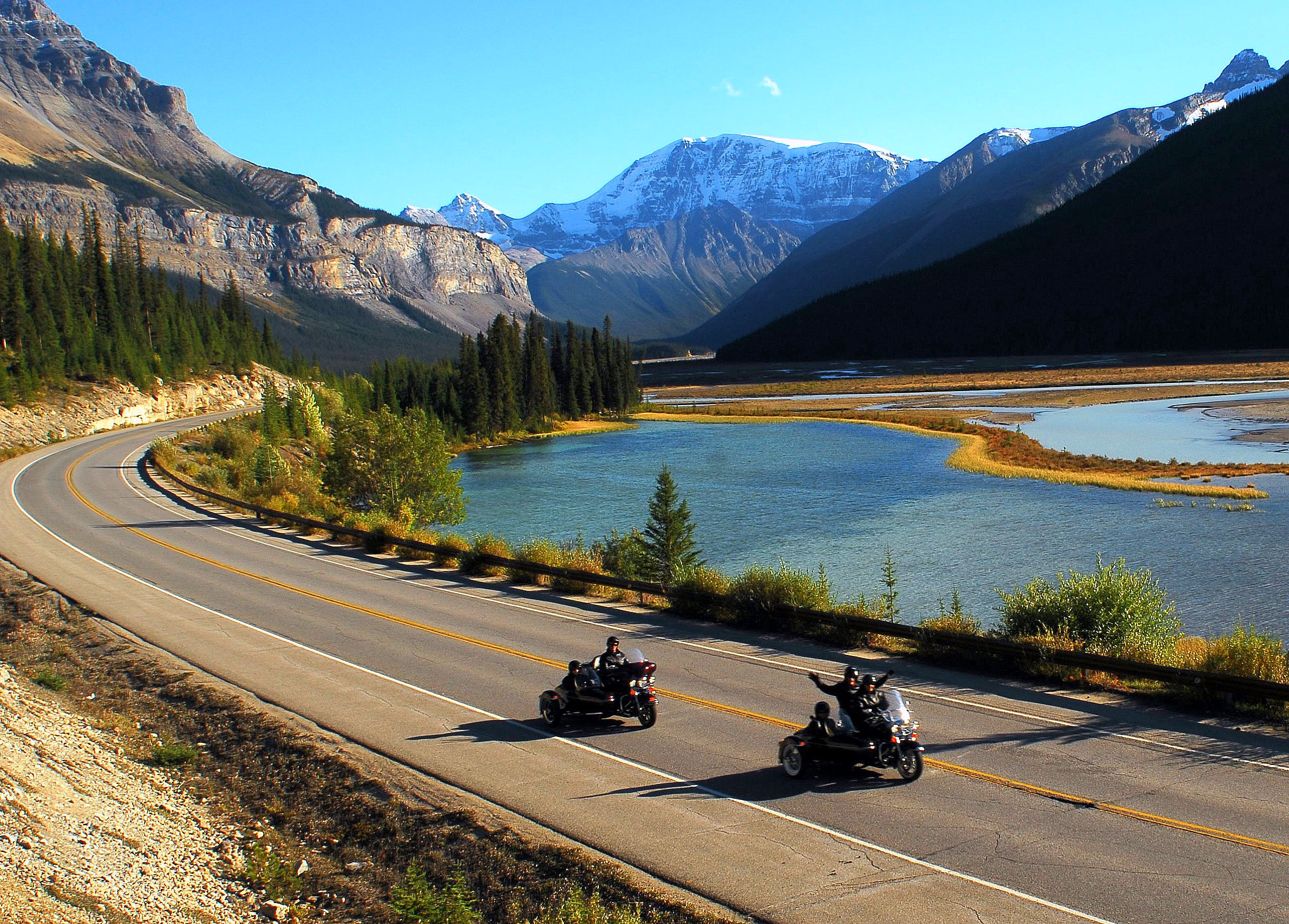 Two motorcycles driving through Jasper National Park on the Icefields Parkway