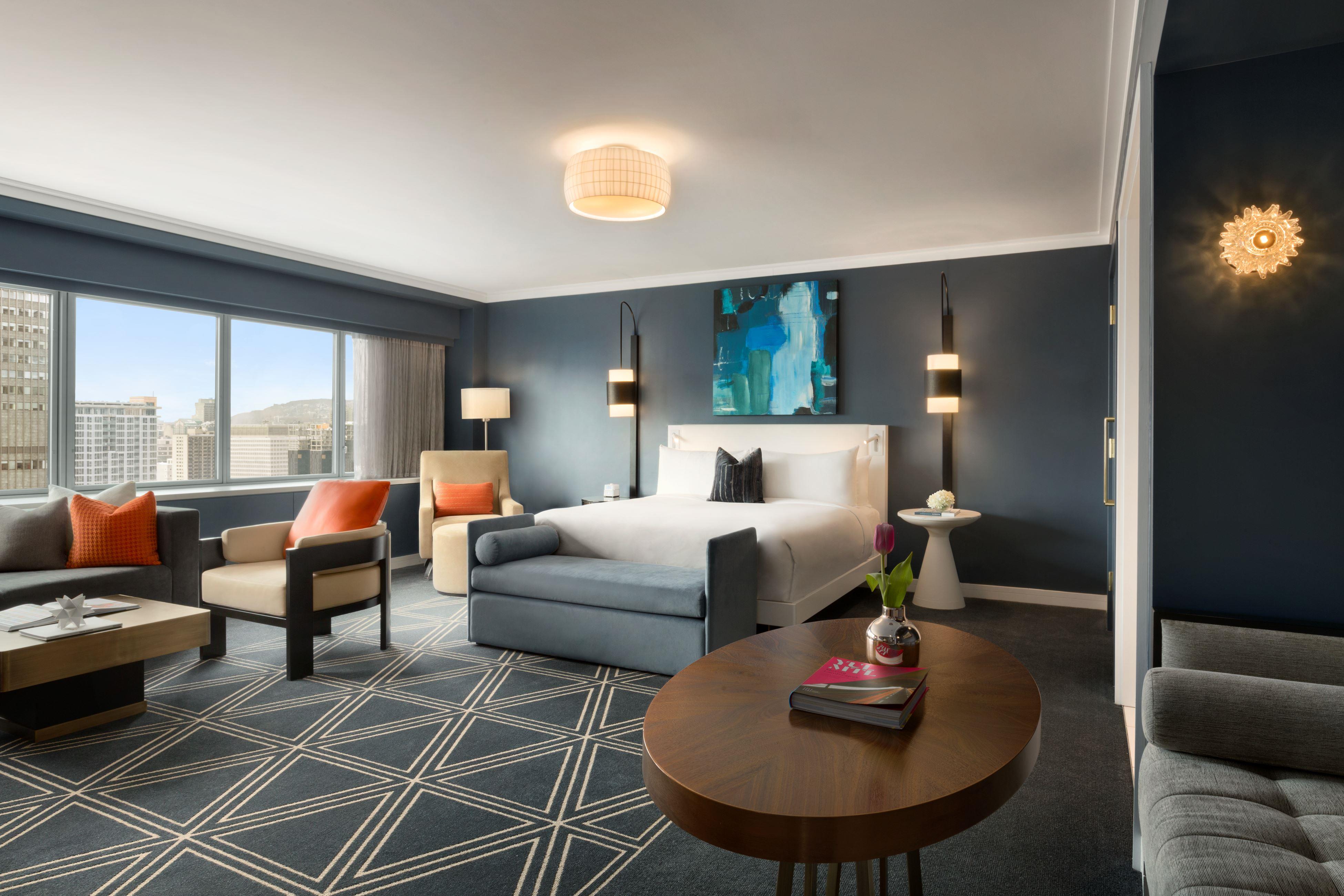 Large hotel room with seating area and large picture windows