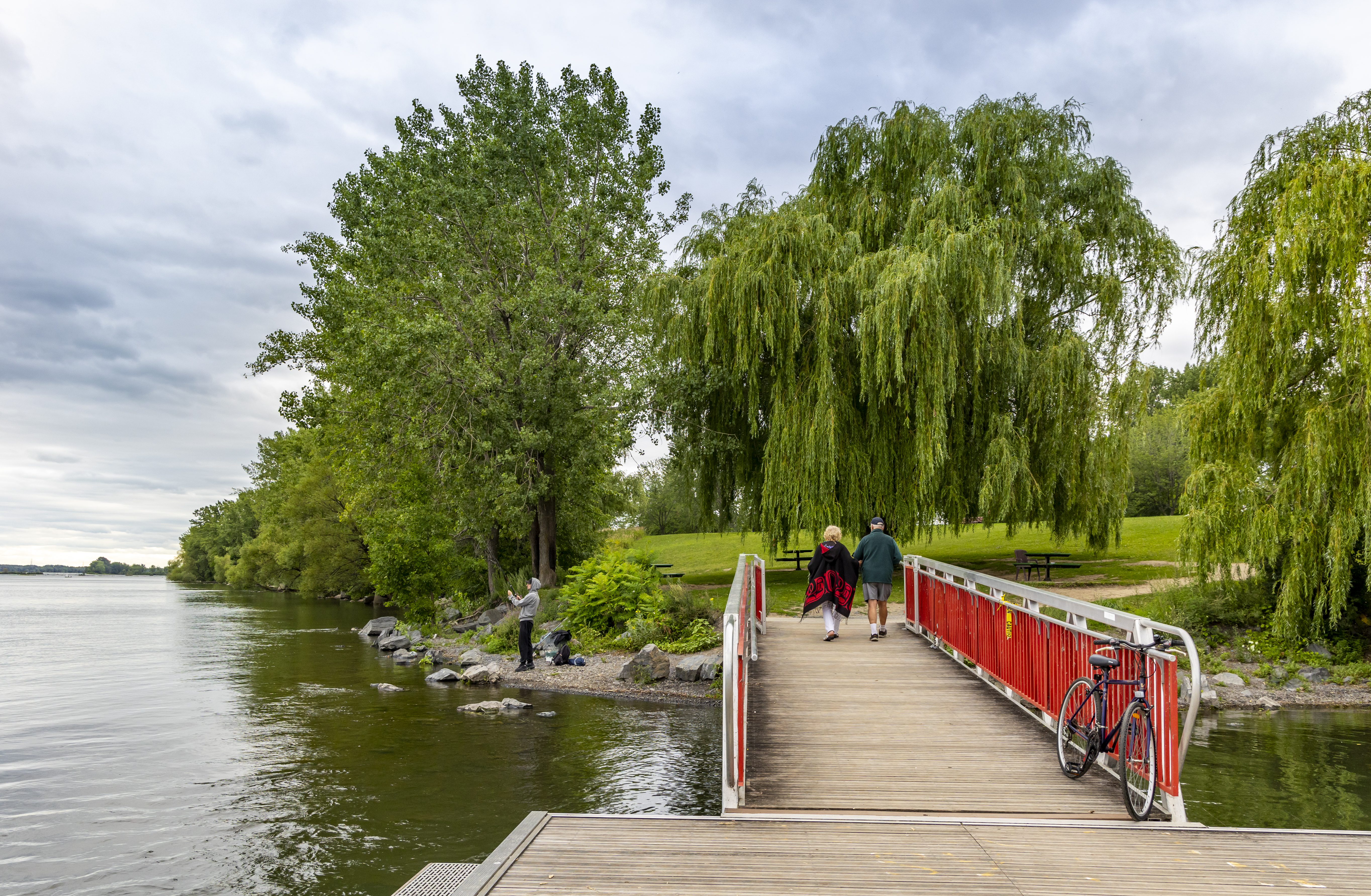 Couple walking alog a bridge at Verdun, Turtle Wharf Park in Montreal