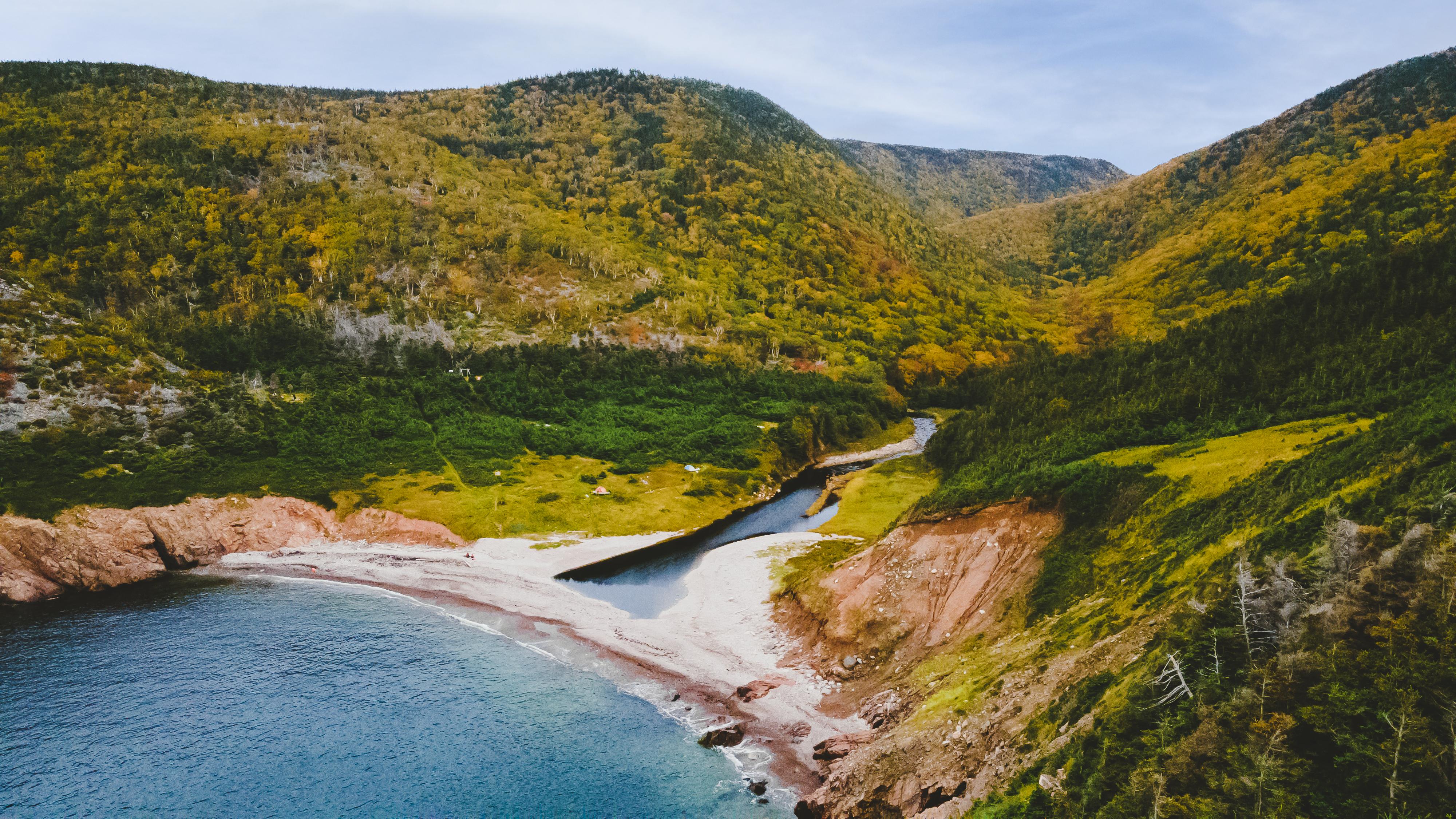 A view of coastline with rugged and lush highlands
