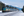 A VIA Rail train travels past snow-capped mountains on snowy train tracks during winter