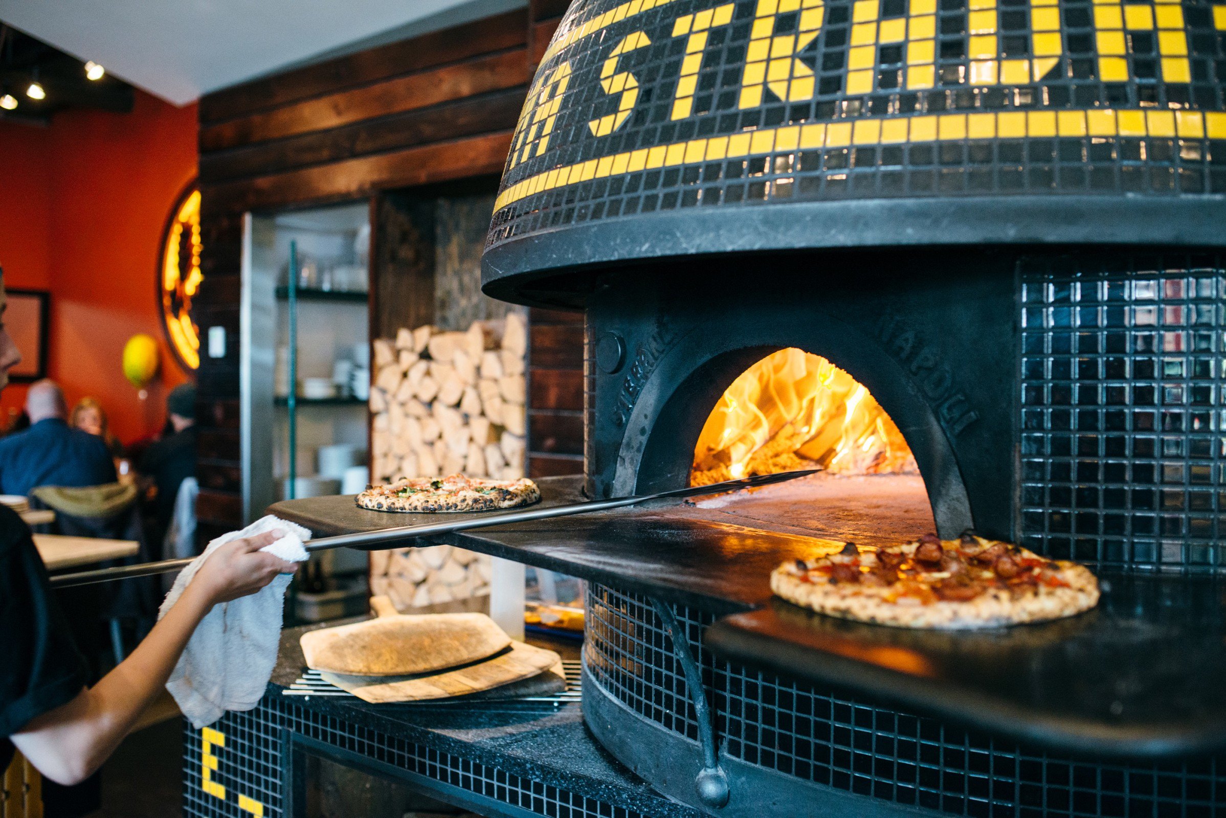 Wood-fired pizza oven at Pizzeria Prima Strada in Victoria.