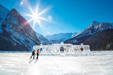 Couple skating past an ice castle in the rockies