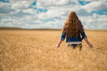 Woman walking through a wheat field