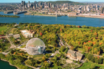 Aerial view of Jean-Drapeau Park, St. Lawrence River and Montreal city on a clear fall day