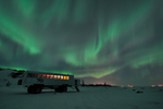 Green Northern Lights above a tundra buggy in Churchill in winter