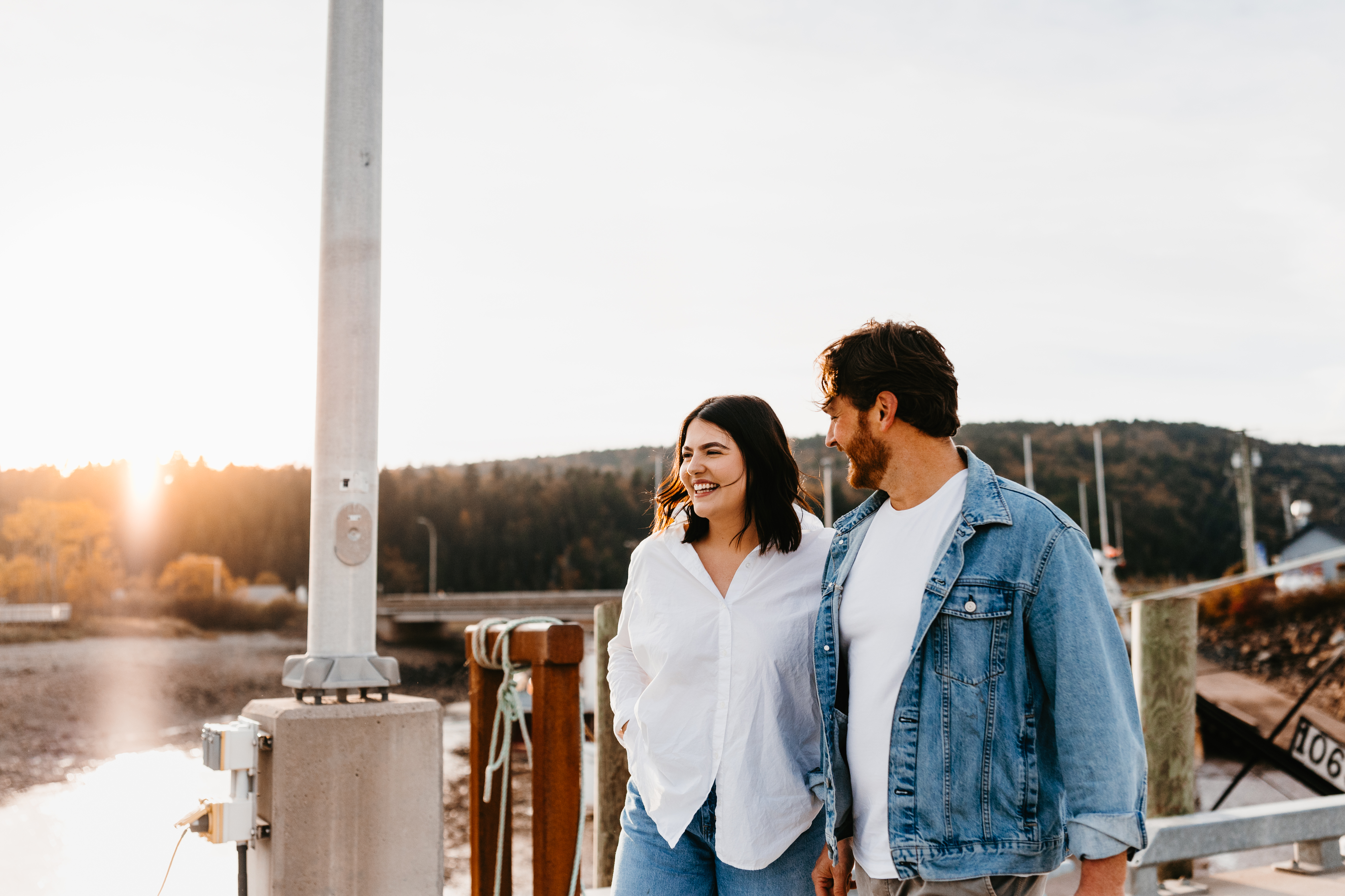Young adult couple joyfully stroll in the village of Alma by the water