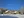 Two log cabins in the snow with blue sky above at Southern Lakes Resort