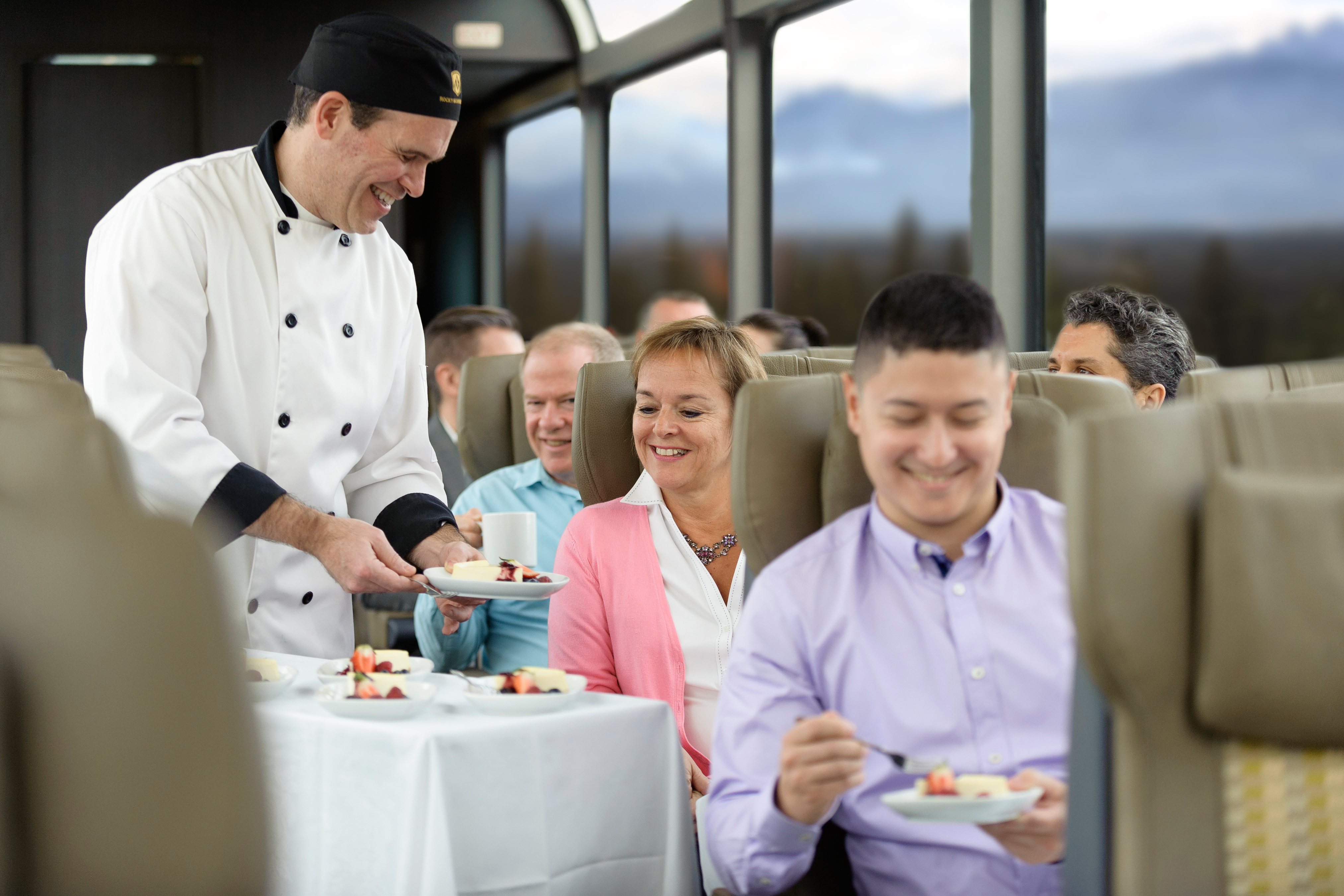 Chef serving breakfast seat side in the SilverLeaf coach of the Rocky Mountaineer train