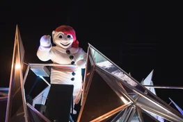 Quebec City's Bonhomme mascot waving in a parade