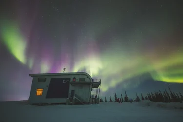 Northern Lights ripple across the sky above the Churchill Northern Lights Studies Centre