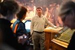 Parks Canada Representative speaking to a small group in a museum