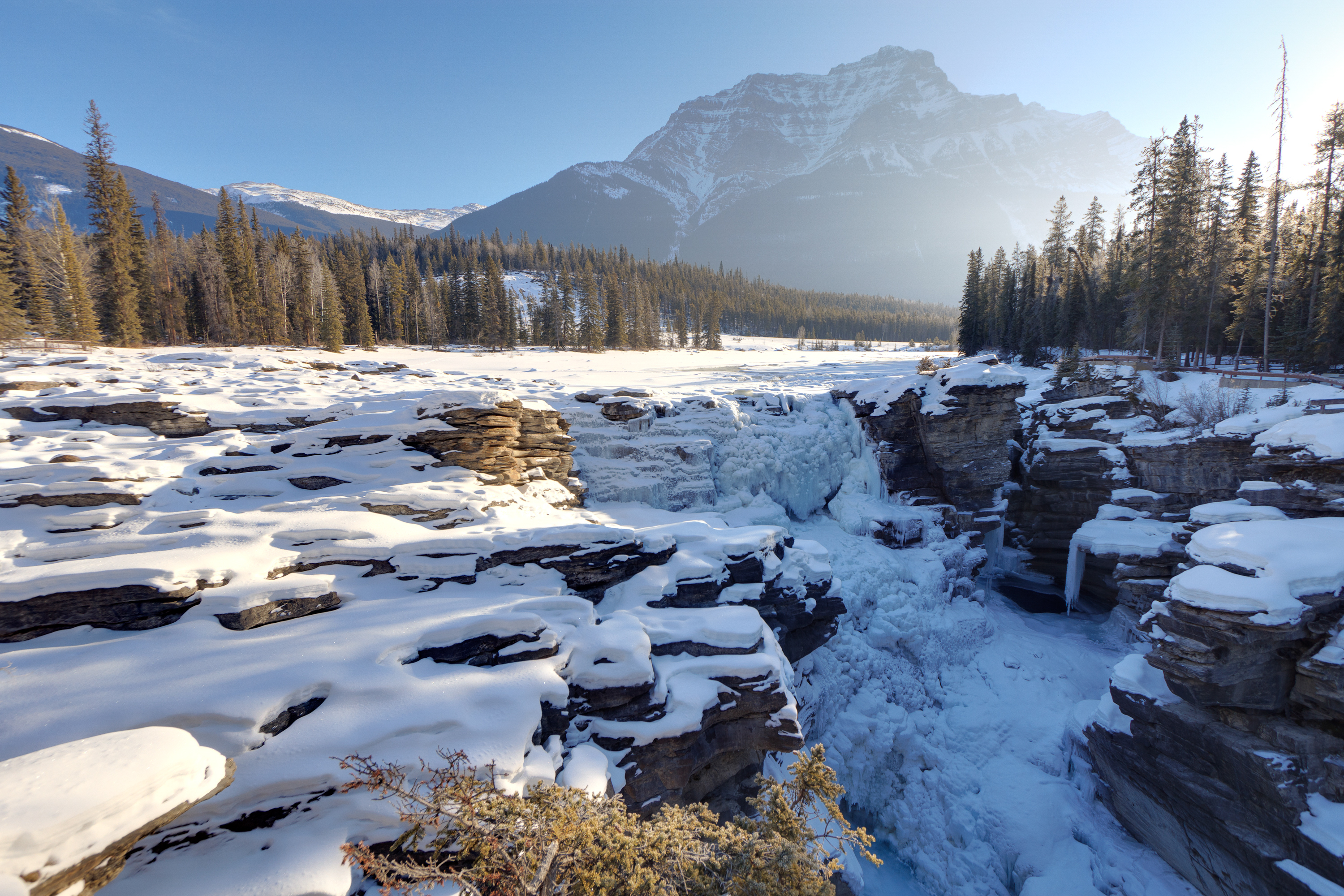 Athabasca Falls in the winter with  snow on a sunny day