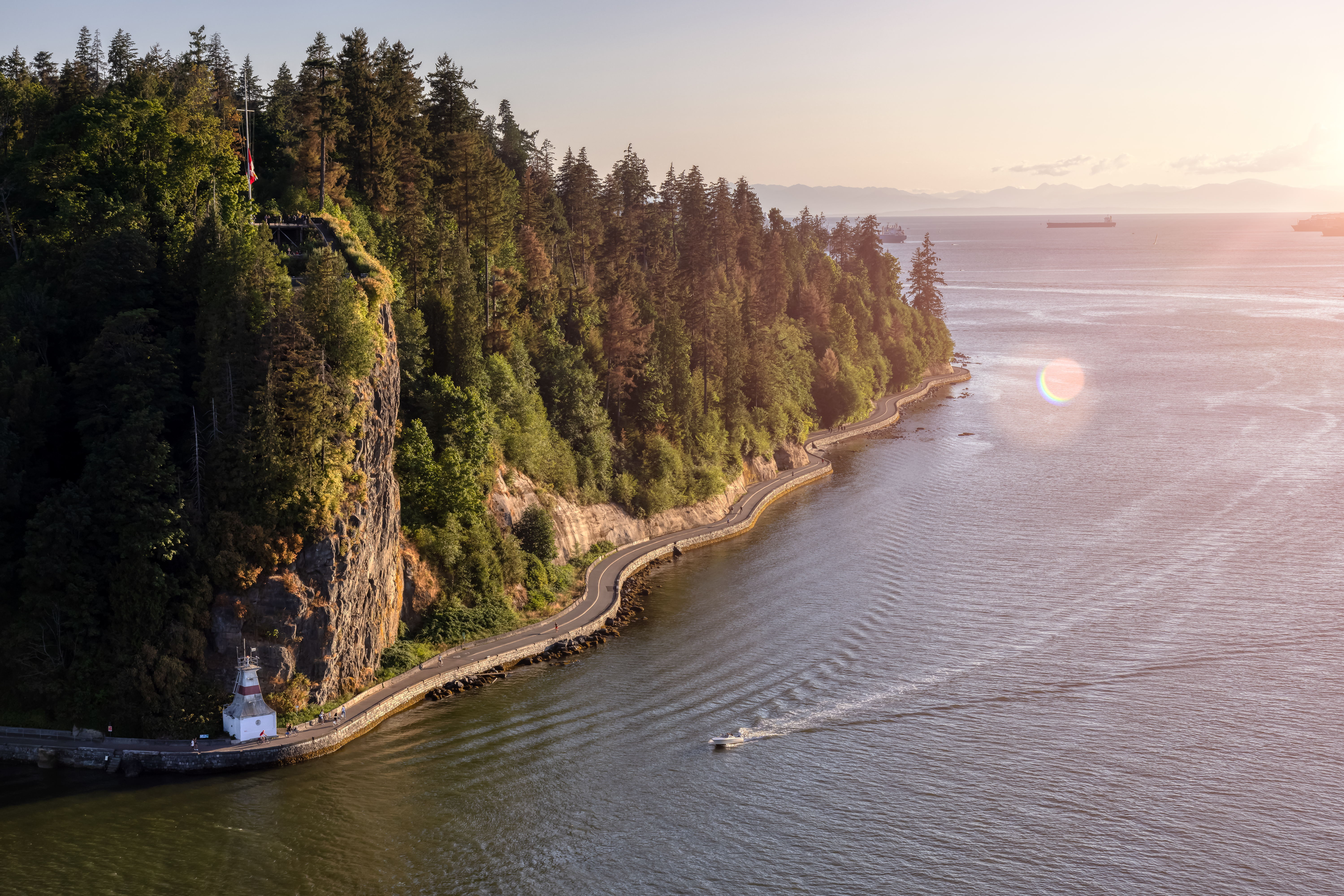 Beautiful sunny sunset with a magnificent landscape view of the trees, ocean and the Seawall coast.