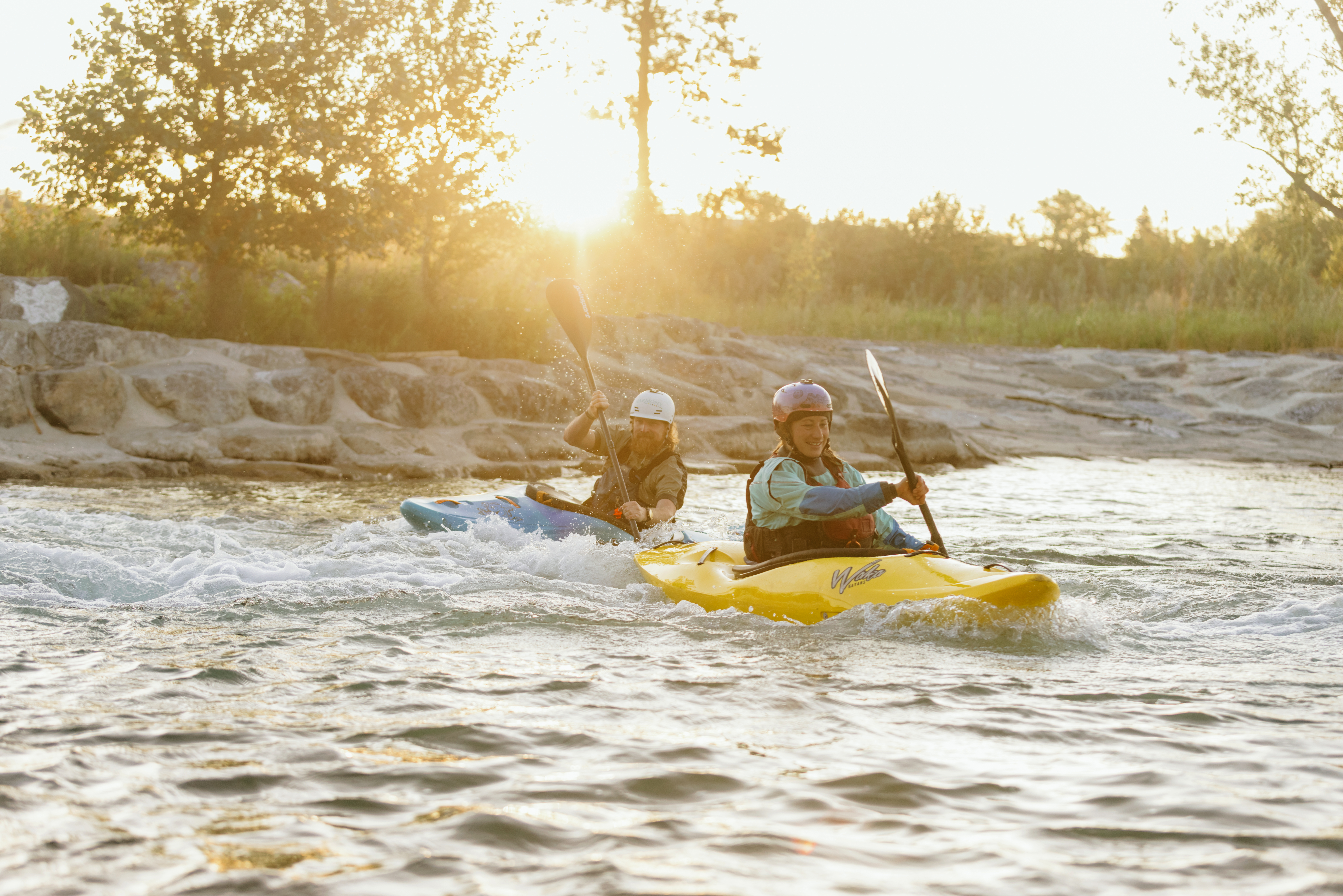 Two kayakers on Harvie Passage as the sun sets