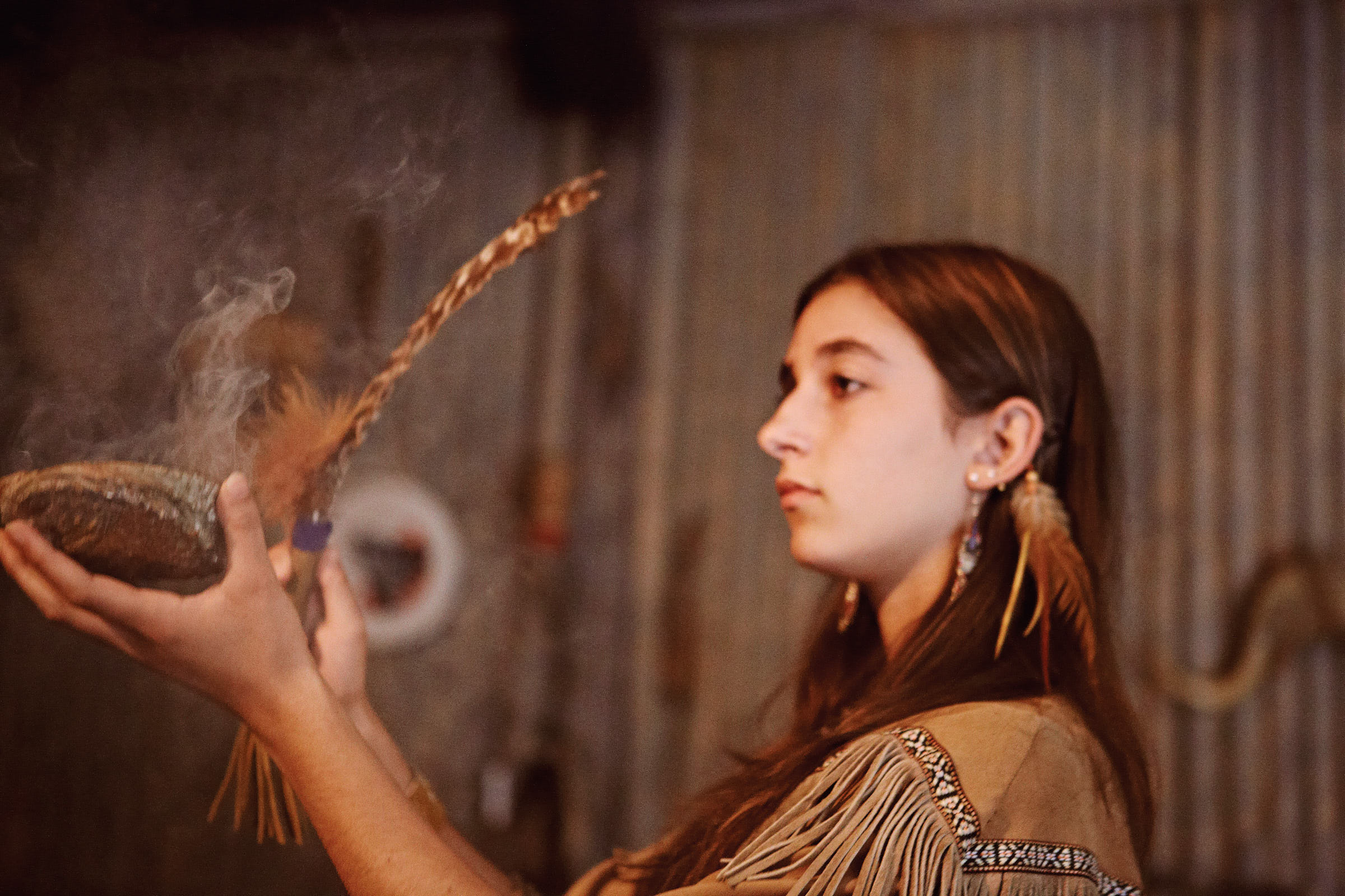 A young Huron-Wendat Indigenous woman performs a smoke ceremony at the First Nations Hotel-Museum