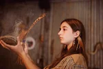 A young Huron-Wendat Indigenous woman performs a smoke ceremony at the First Nations Hotel-Museum