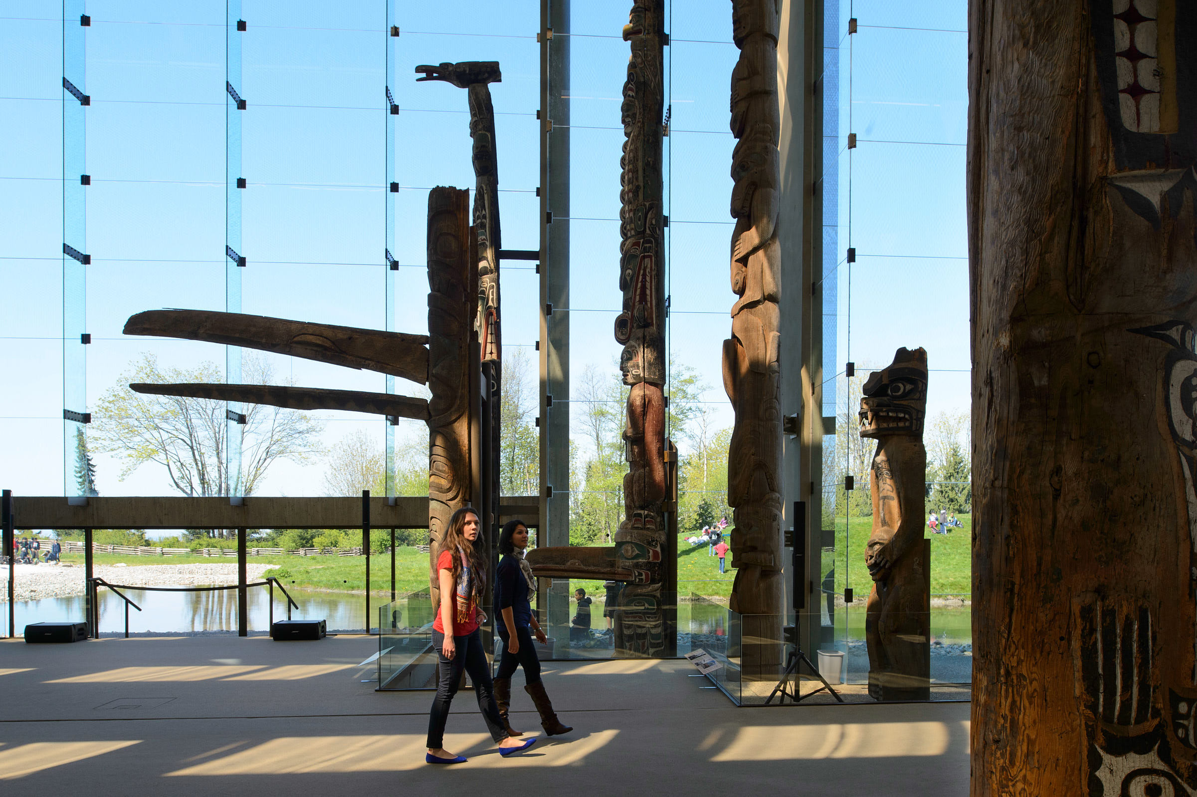 Two women walk through an exhibit at the Museum of Anthropology 