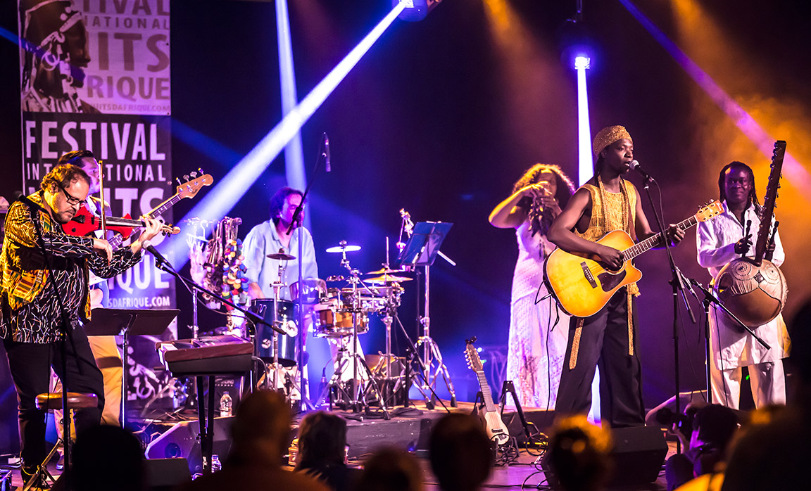 Close up of a band playing on stage at the International African Nights Festival