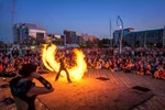 A large crowd at Busker's Festival watches a flame throwing show