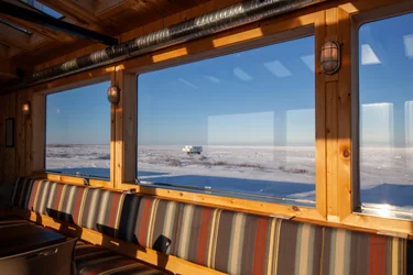 View of seating and large windows in Thanadelthur Lounge with snowy landscape outside