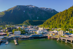 The city of Juneau in front of mountains on sunny summer day 