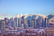 The city of Vancouver skyline with snowy mountains behind