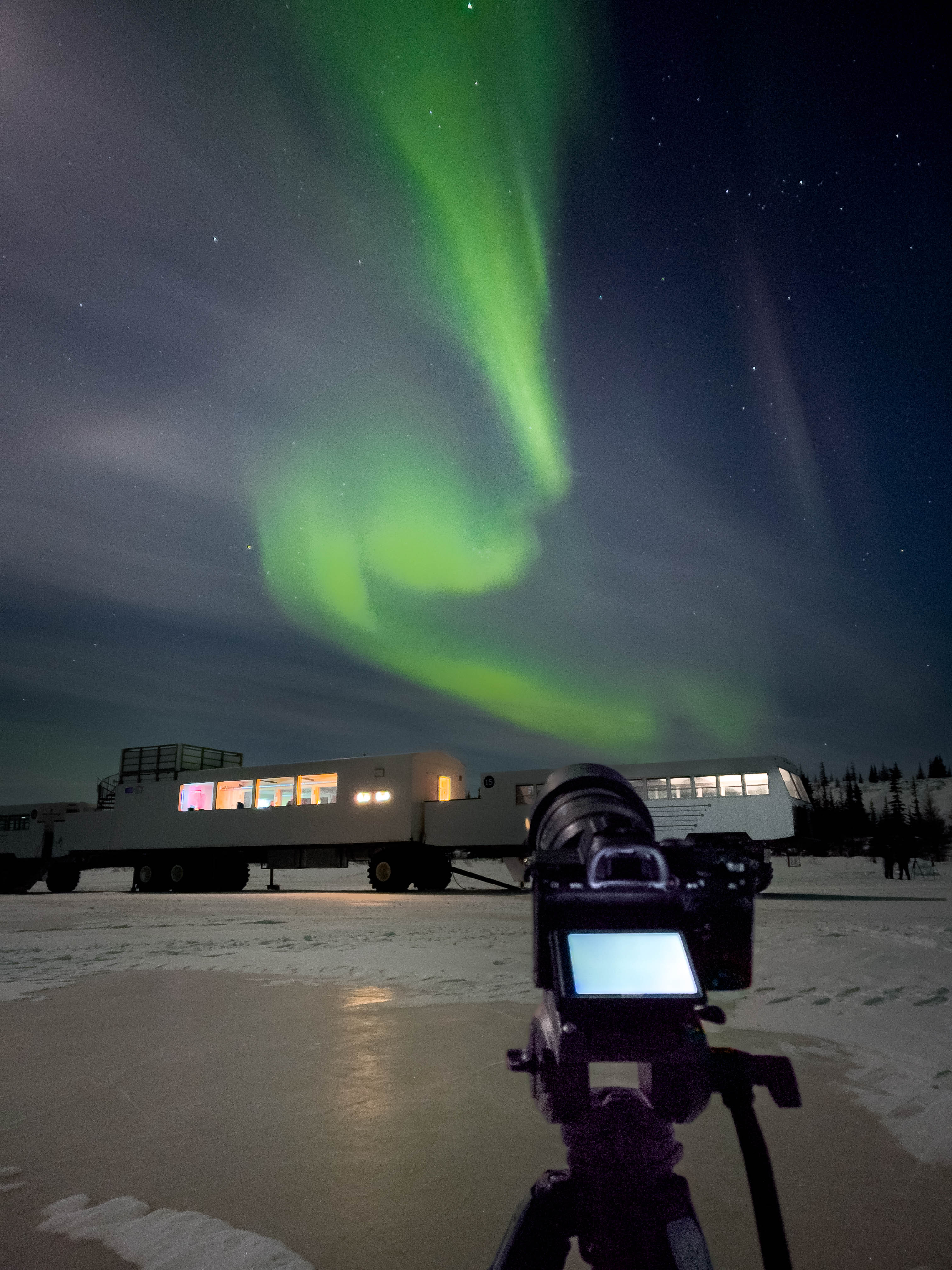 Camera facing Tundra Buggy on icy terrain in the province of Manitoba, Canada