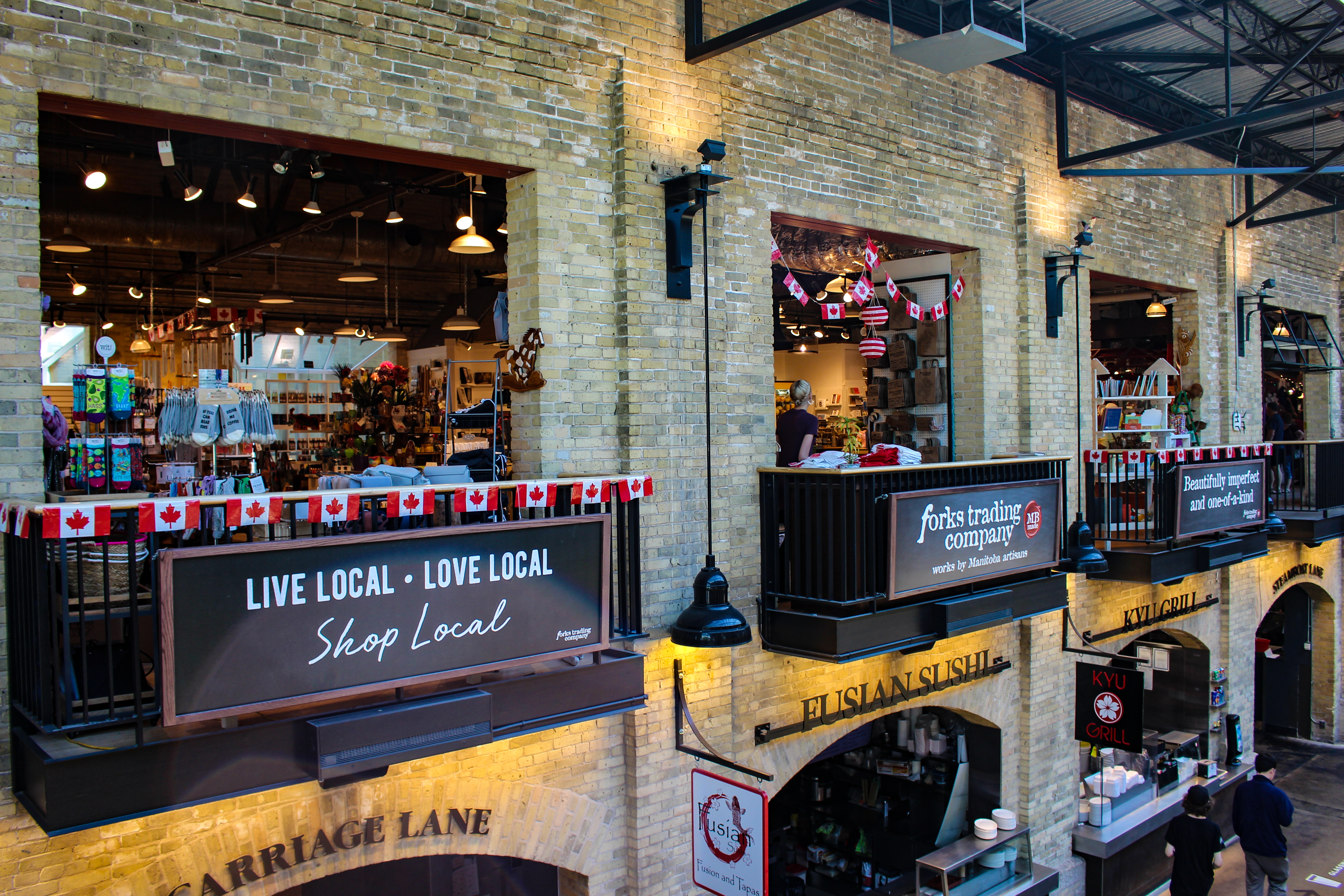 View of shops and eateries across two levels inside the Forks Market
