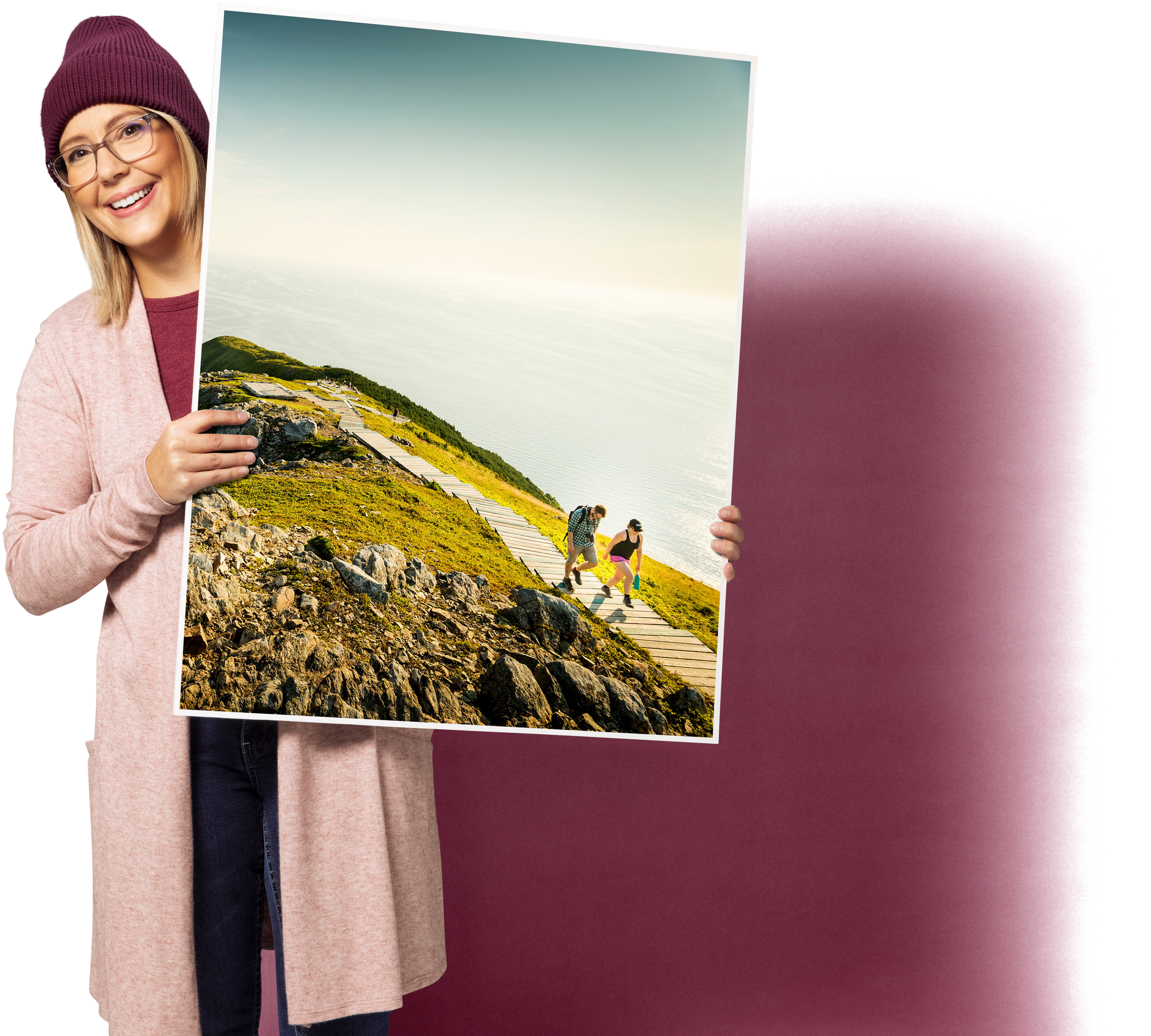 A person holding a large sign board with Canadian scenery on it