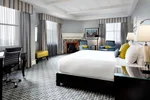 Luxury hotel room with a fireplace and large windows at the Fairmont Royal York 