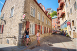 Two women standing in one of Quebec City’s cobblestone streets