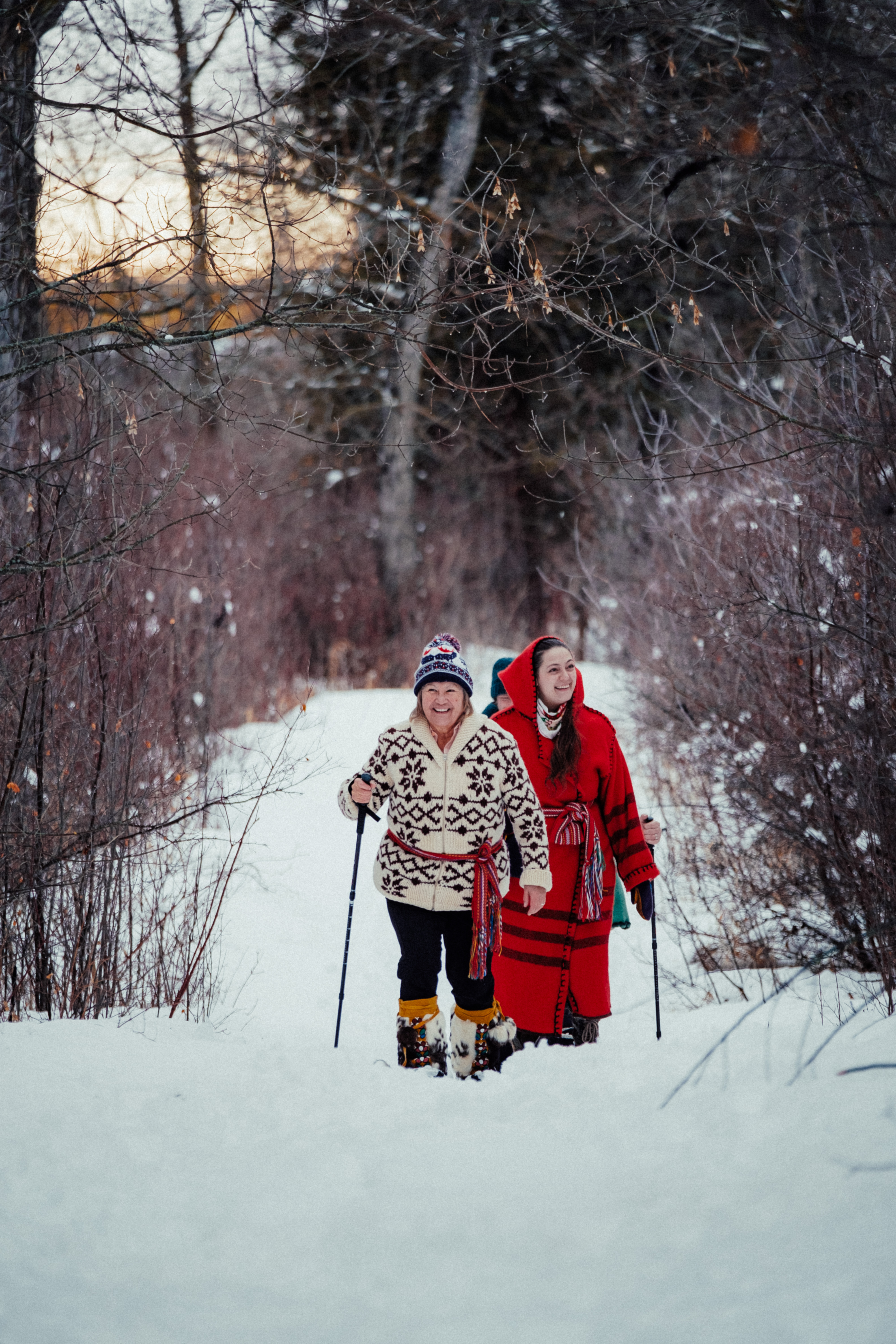 Small group snowshoeing through the winter landscape by Métis Crossing