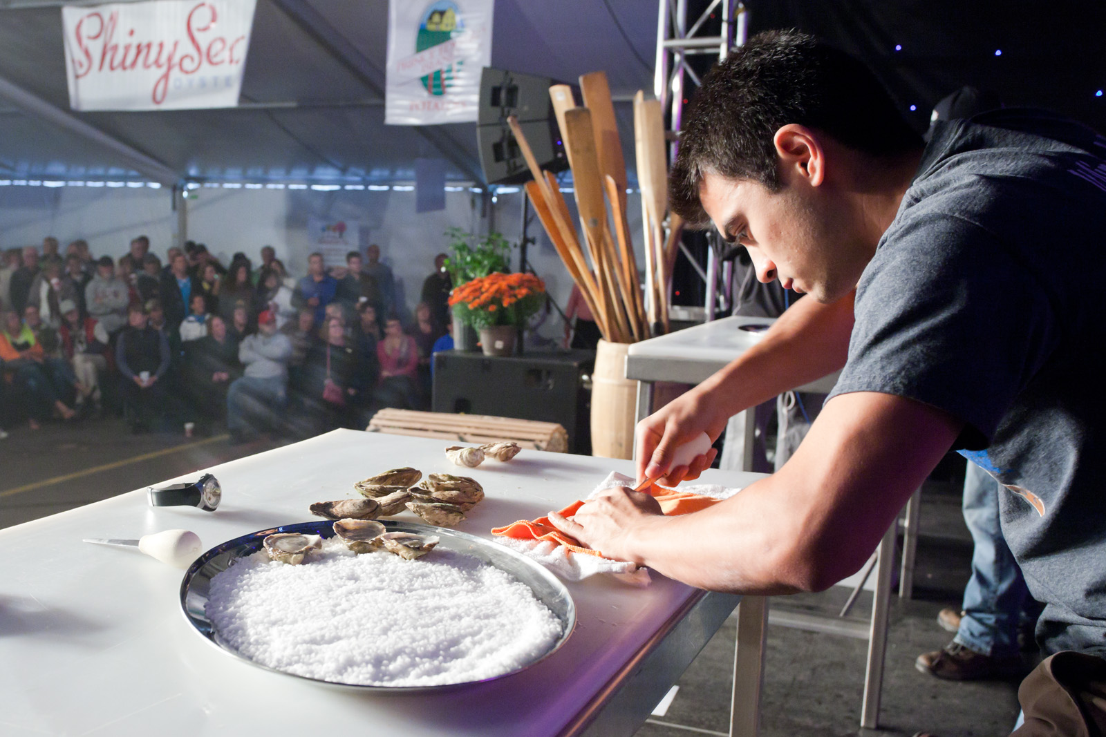 A person participating in an oyster shucking competition at the PEI Shellfish Festival