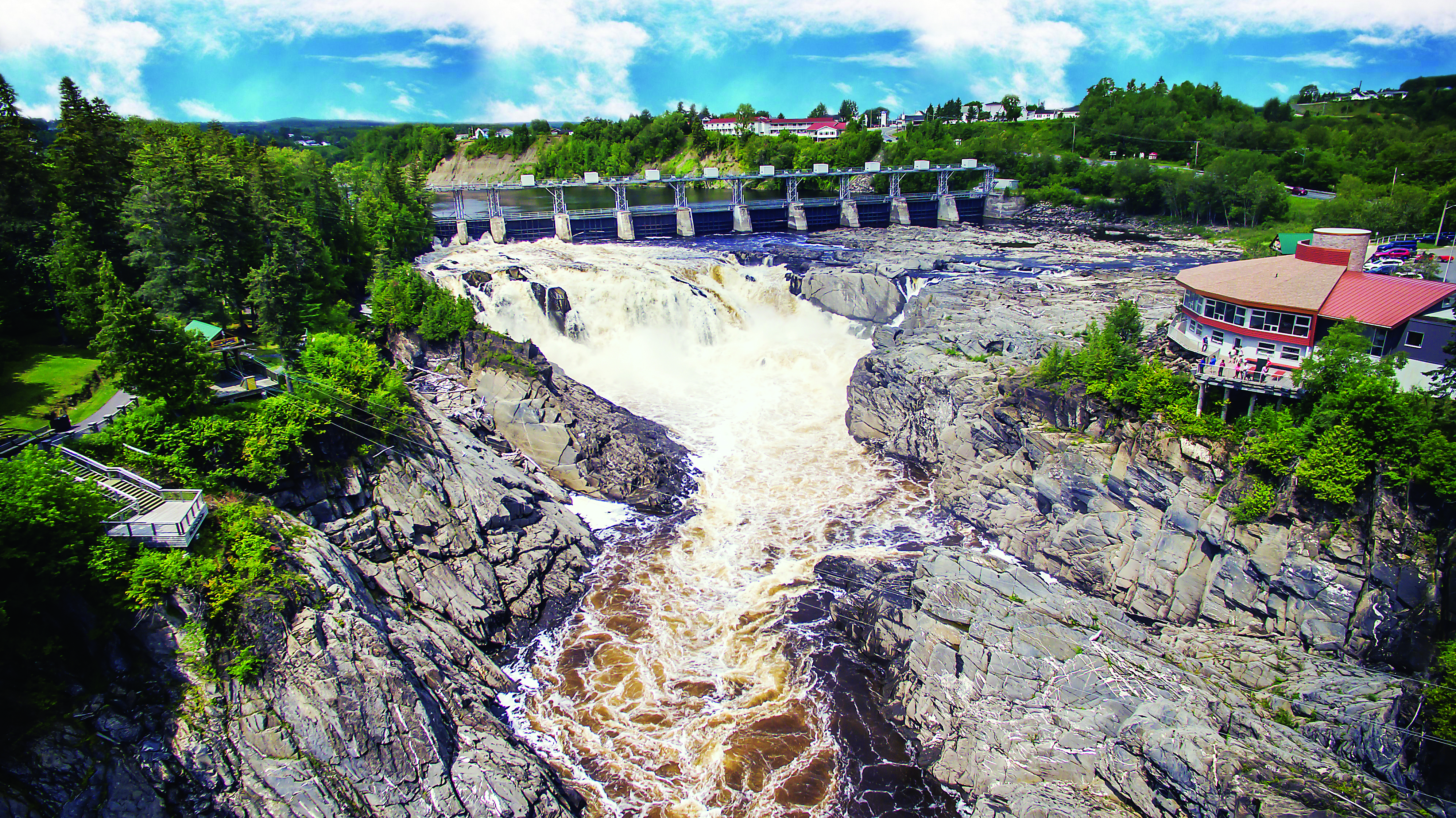 Water rushes down jagged and rocky gorge located beside lookouts in Grand Falls, New Brunswick