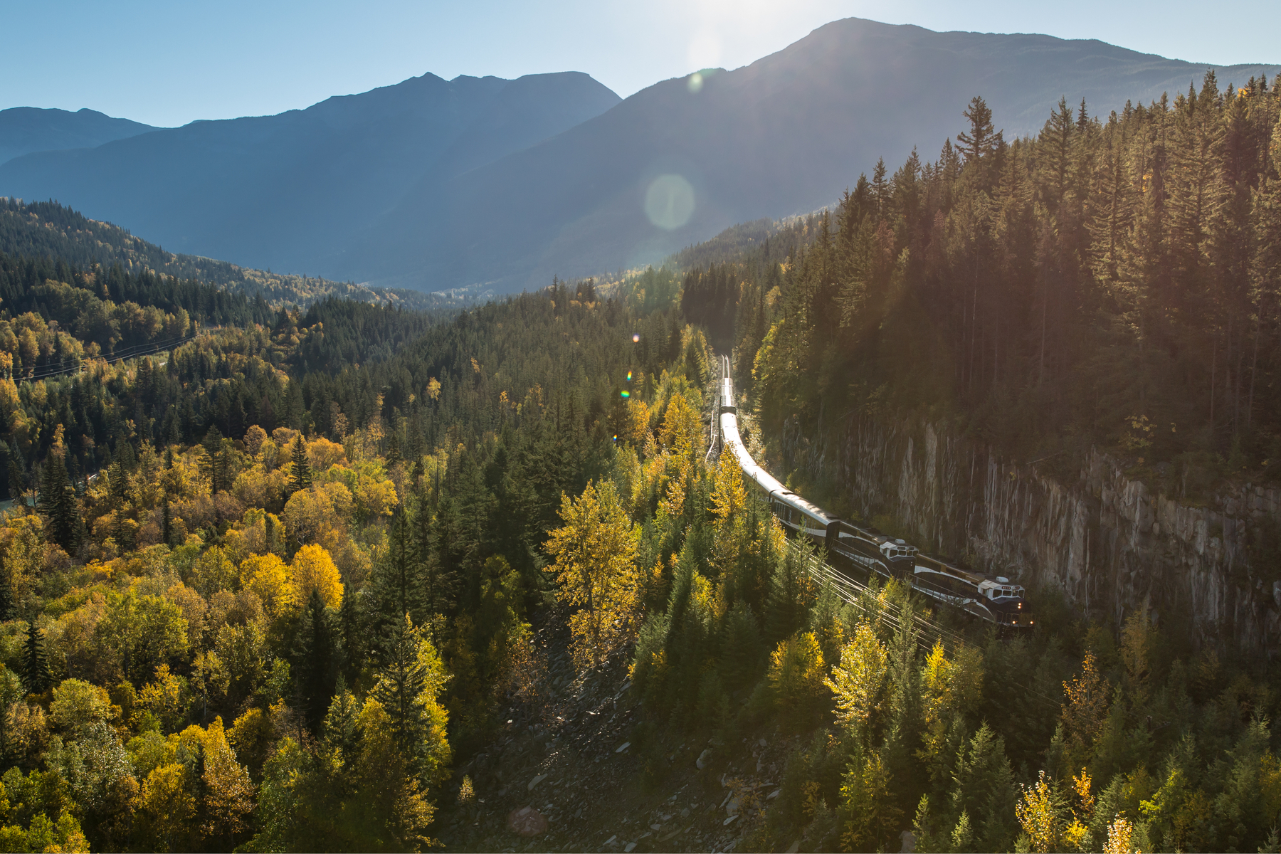 Rocky Mountaineer train on the Journey Through the Clouds route through the mountains in fall season
