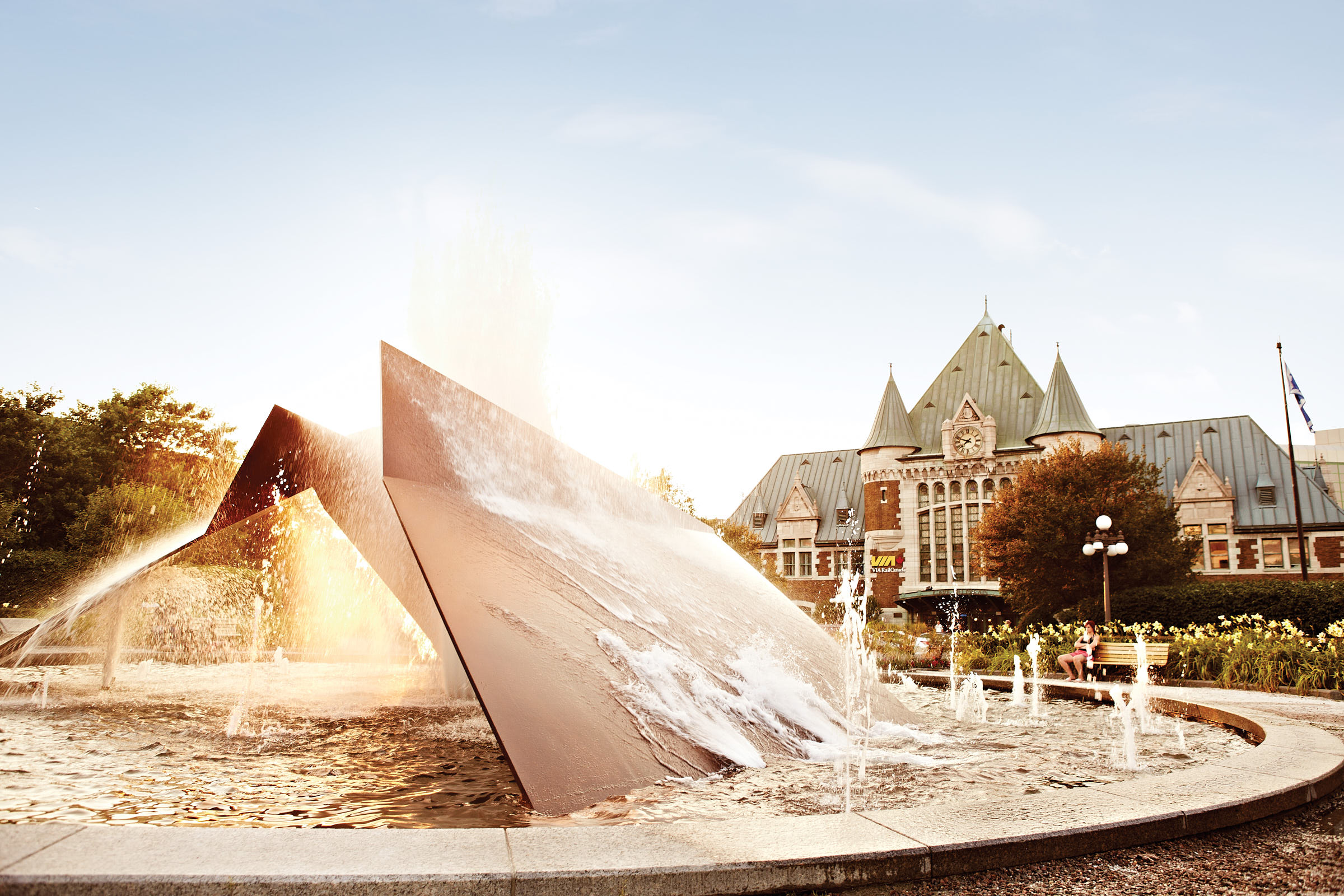 A modern water fountain pumping water in front of Via Rail's Gare Du Palais station in Quebec City