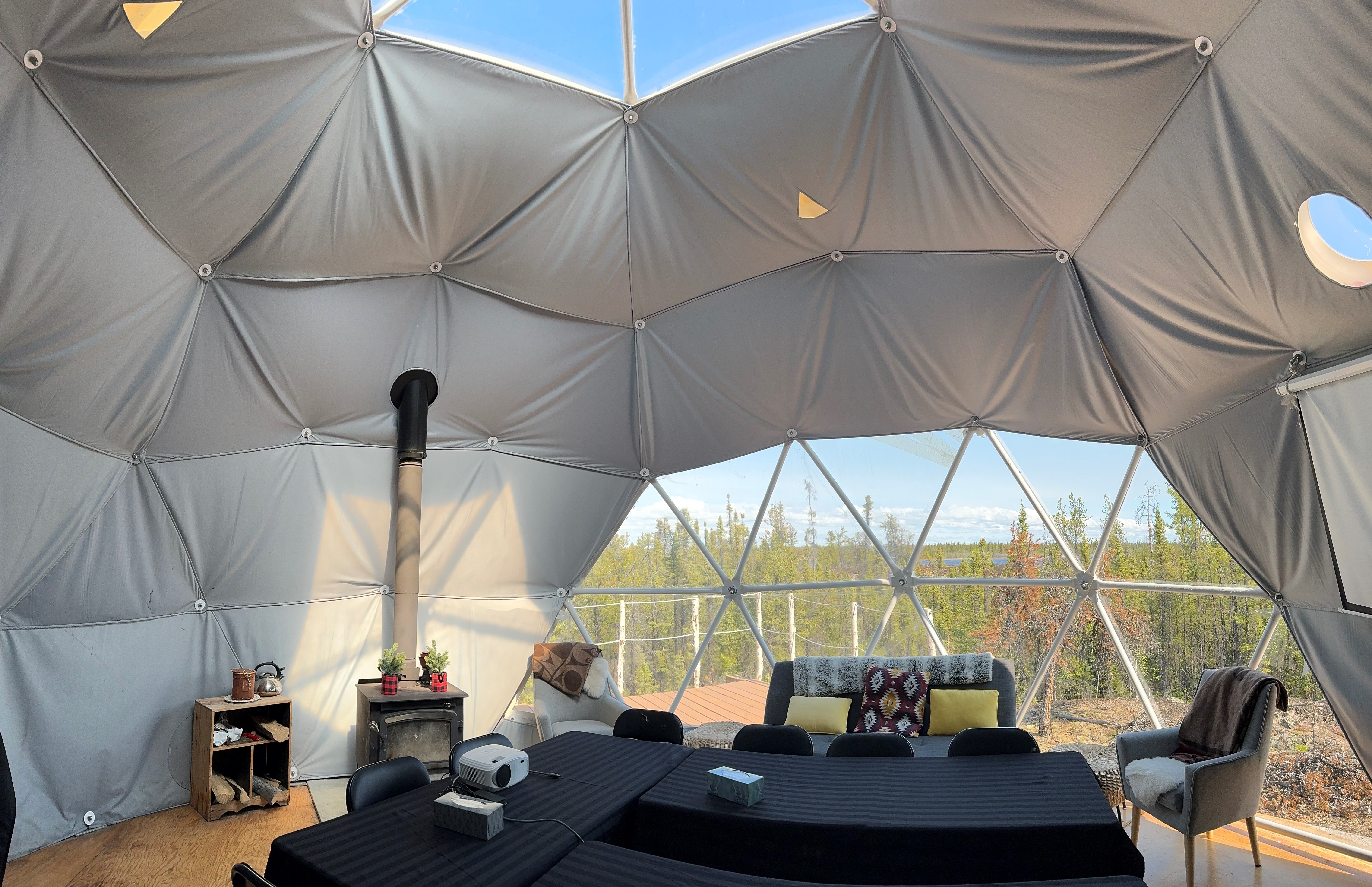 A dome shaped room with a table and chairs inside of it