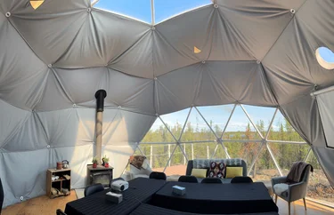 A dome shaped room with a table and chairs inside of it