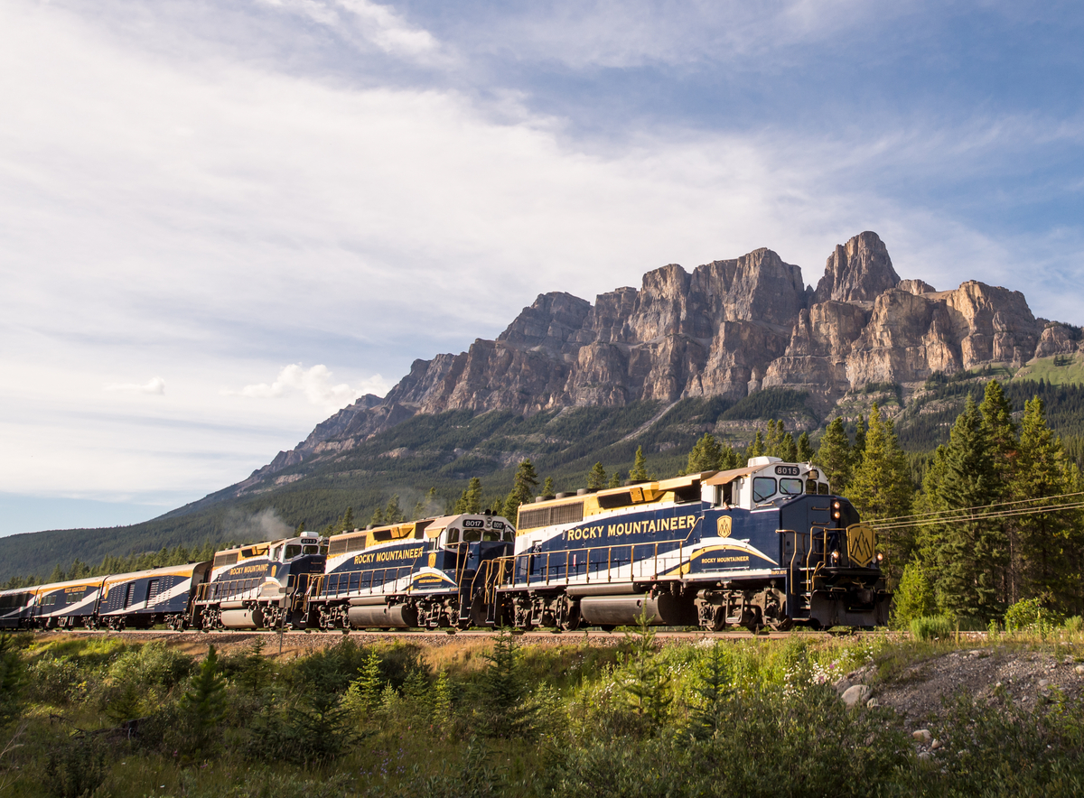 The Rocky Mountaineer train passing by Castle Mounain in the Canadian Rockies