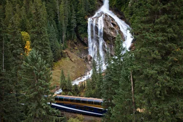 The Rocky Mountaineer train passing Pyramid Falls on the Journey Through the Clouds route.