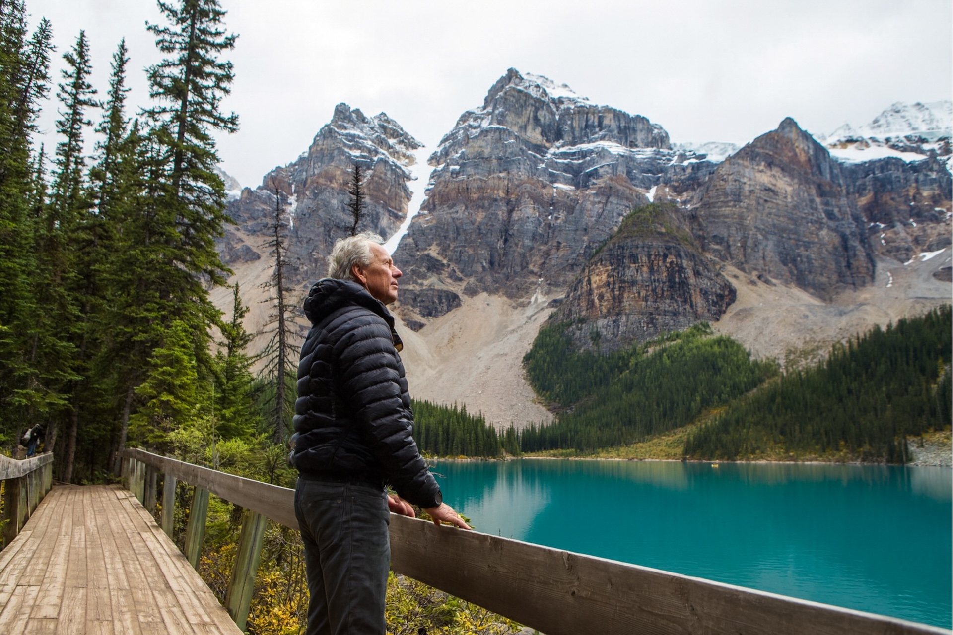Man standing on boardwalk admiring mountain