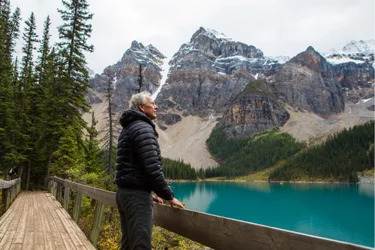 Man standing on boardwalk admiring mountain