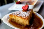 Pouding Chomeur - Traditional dessert in the Provincial Quebec, Maple Pudding Cake with heavy cream and maple sauce drizzled on it