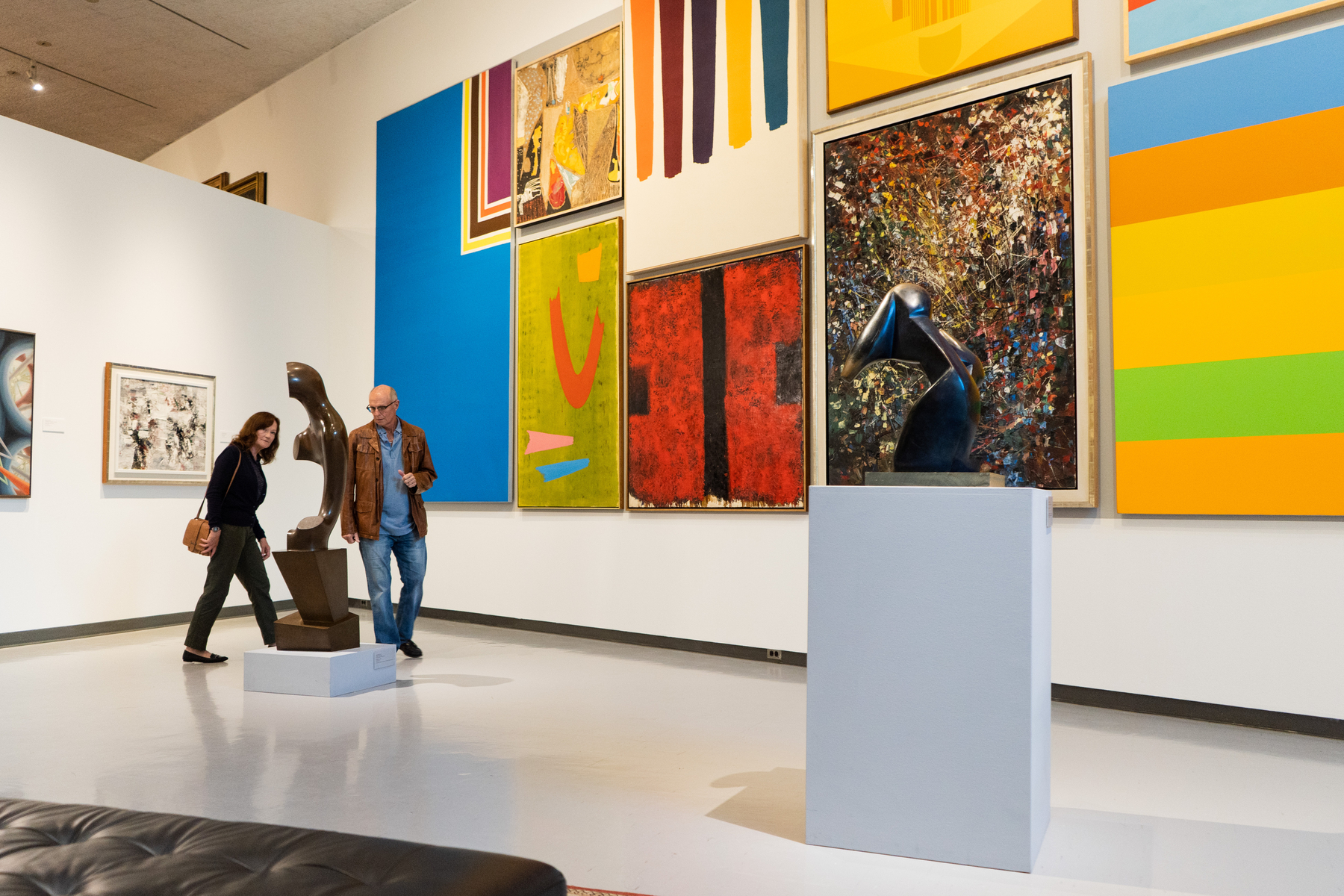 Couple looking at modern art sculptures and colourful abstract paintings in the Winnipeg Art Gallery