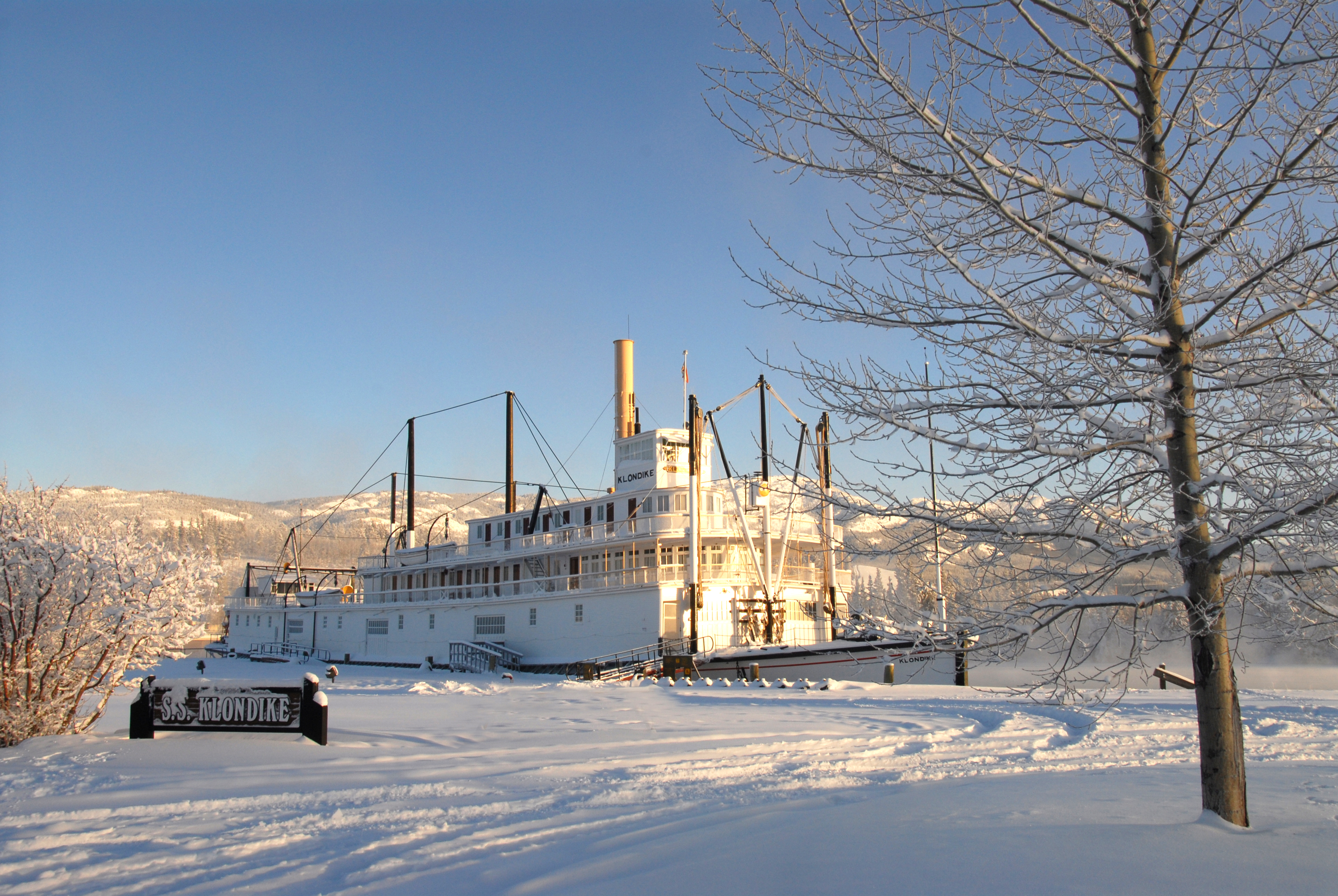 National historic site of Canada and outdoor exhibit of the S.S. Klondike vessel on the Yukon River's bank after snow