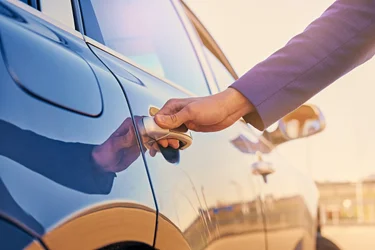 A person opening a car door