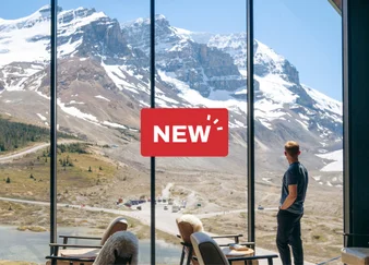 A man looks through the window at Glacier View Lodge.