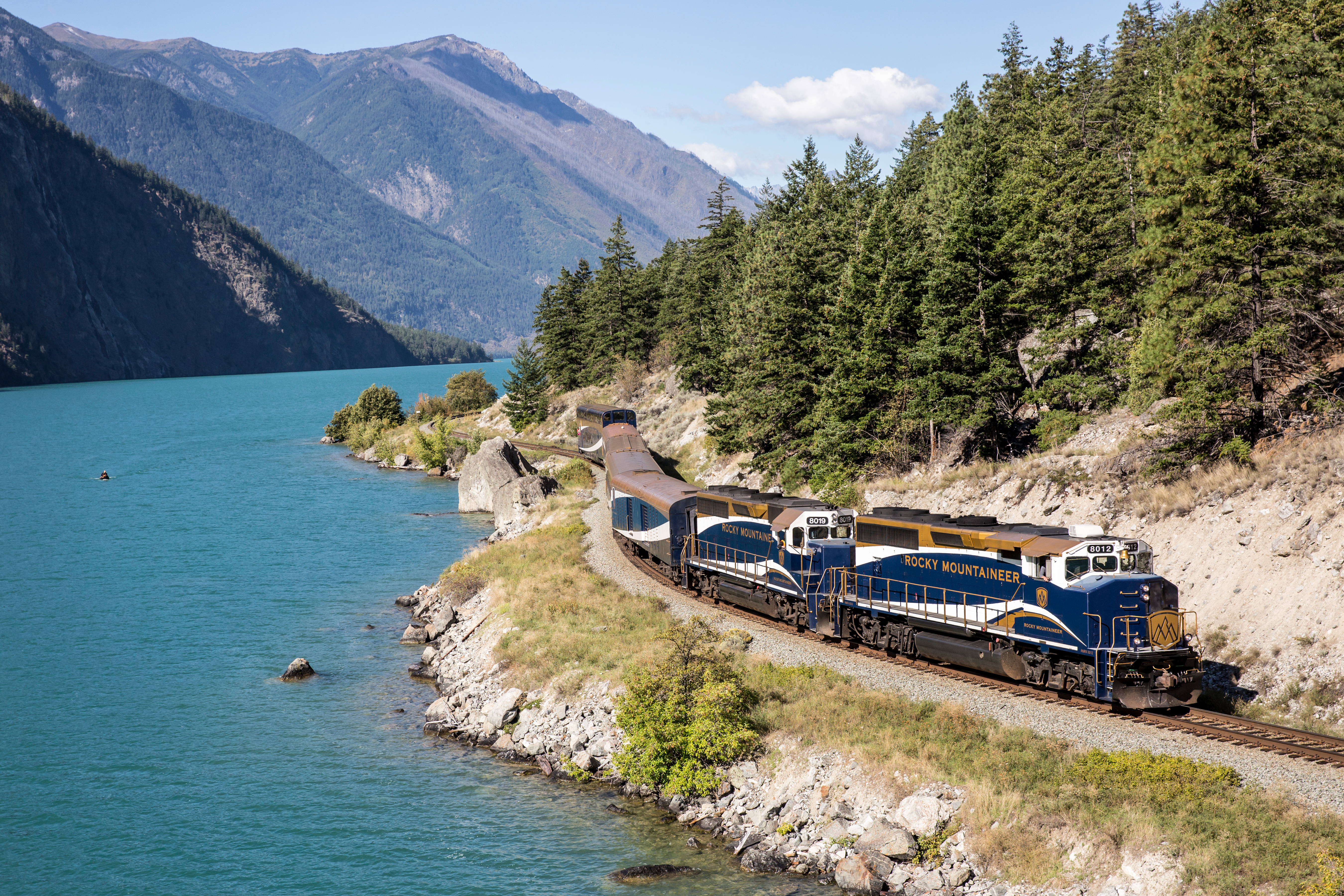 The Rocky Mountaineer rounds the bend alongside the azure waters of Seton Lake, BC.