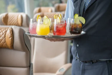 Close up view of host serving drinks in GoldLeaf on Rocky Mountaineer